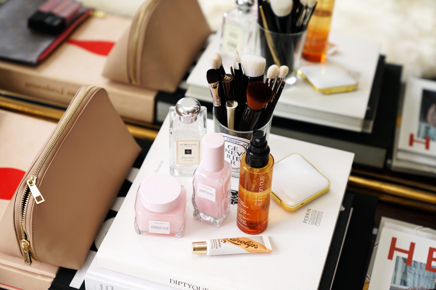 The Daily Edited Large Cosmetic Bag, Glow Recipe Watermelon Sleeping Mask, Glow Recipe Watermelon Juice Moisturizer, Shu Uemura Art of Hair Serum and Lanolips Coconut Balm