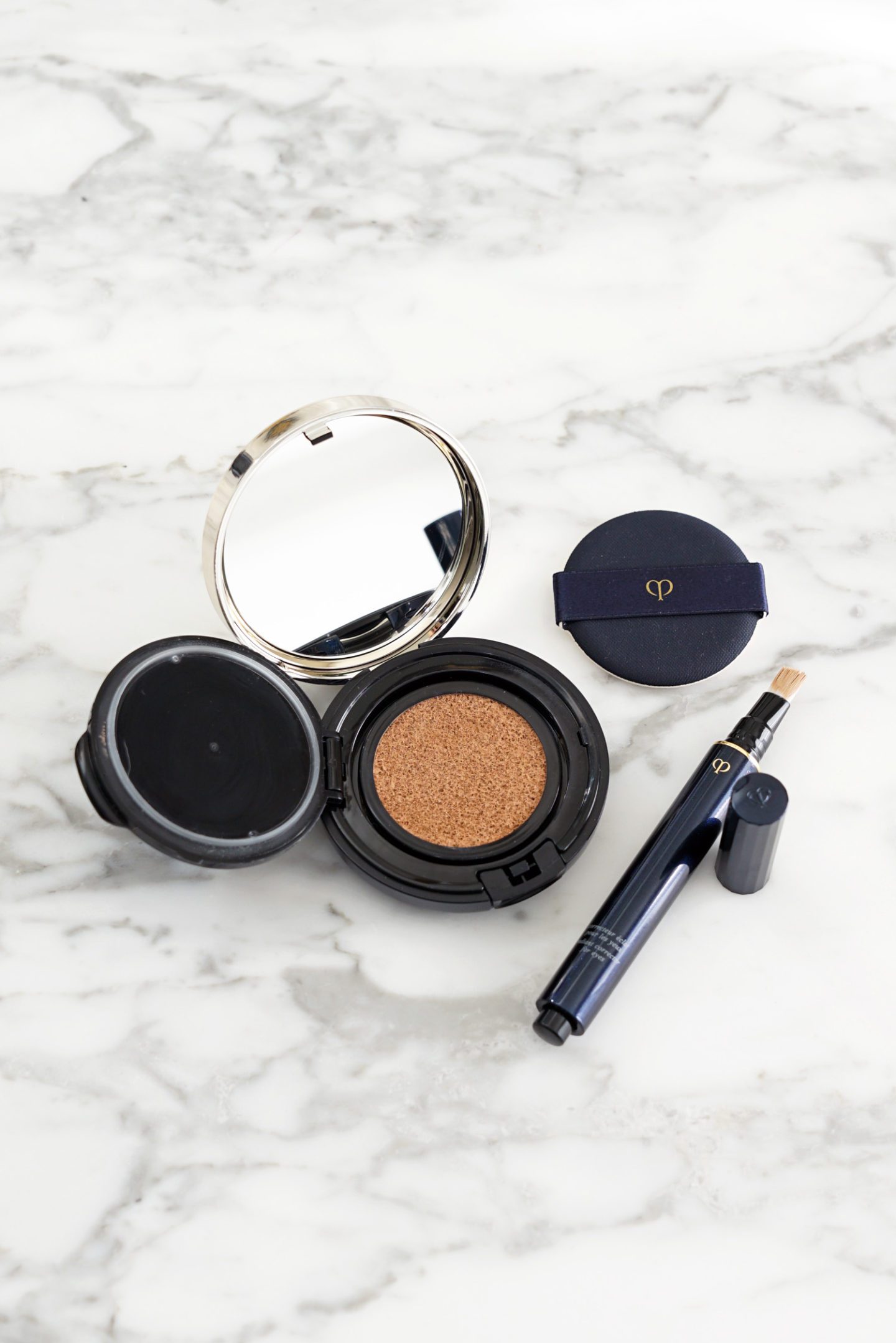 Cle de Peau Radiant Cushion Foundation in O30 and Corrector for Eyes in Ocher | Fashion Groom Spot